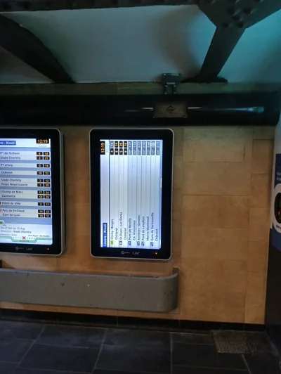 A sideways public display screen in a subway station